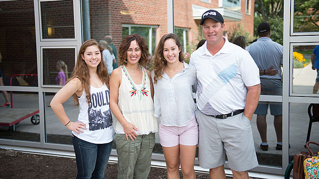 Brockport student posing with her family outside the dorms on Move In Day