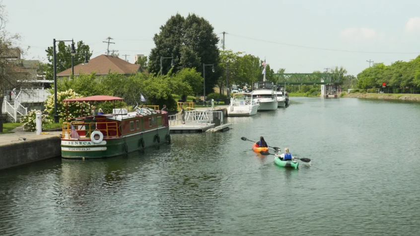 Two people kayaking on the Erie Canal near the Brockport Welcome Center