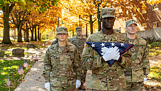 ROTC students walking to the flag poles in the Campus Mall for the Flag Raising Ceremony on Veterans Day