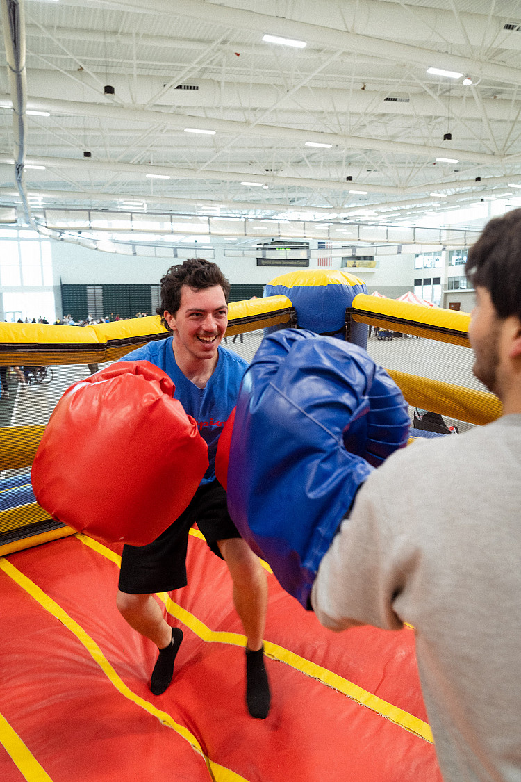 Student in an inflatable boxing ring at Eagle Day