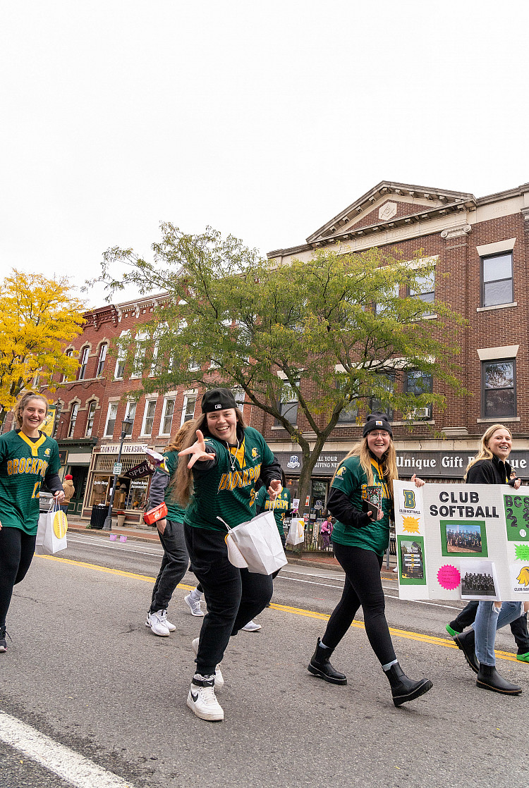 Club Softball throwing candy at the 2023 Homecoming Parade