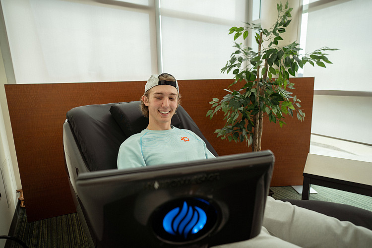 Student sitting in a massage chair in the SERC