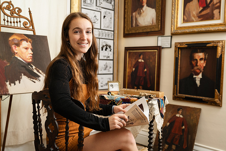 history student looking at book in a museum