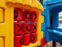 A tic tac toe board set into a playground