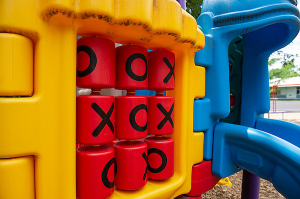 A tic tac toe board set into a playground
