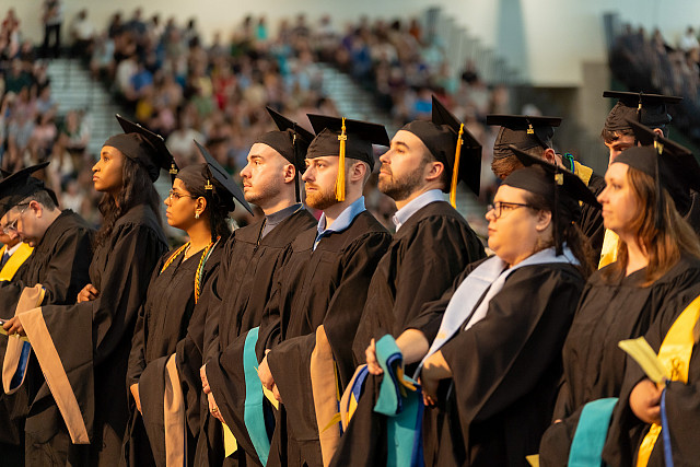 graduates posing at commencement