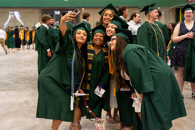 graduates posing at commencement