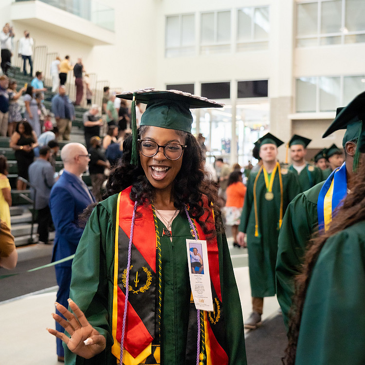 graduate walking into commencement