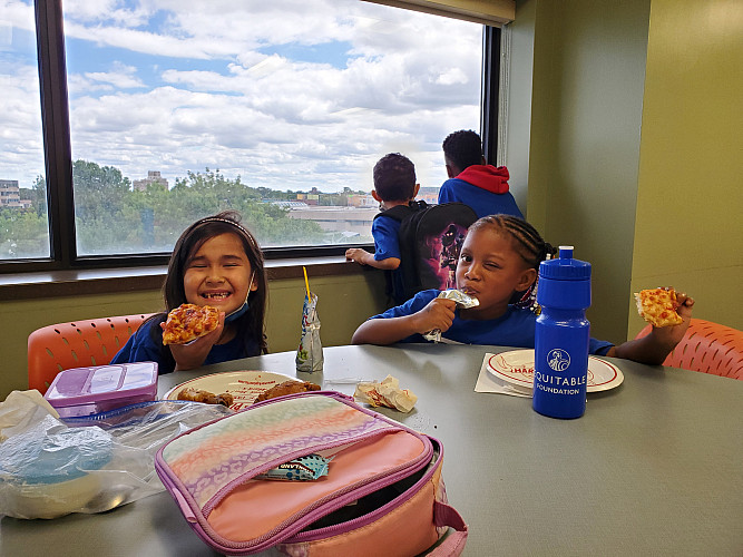 Children having pizza at a table