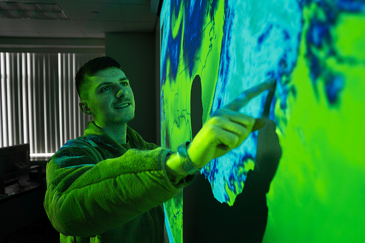 Meteorology students use data from radars and satellites to view simulations of oncoming weather patterns.