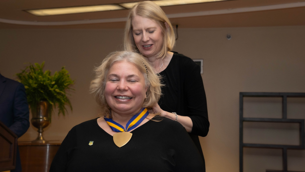 Melissa Furness accepting a Chancellor's Award medal from Heidi MacPherson