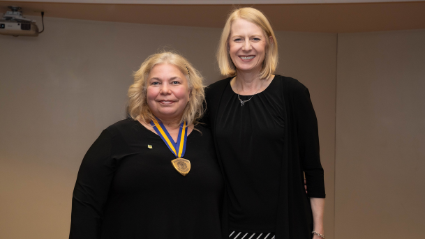 Melissa Furness accepting a Chancellor's Award medal from Heidi MacPherson