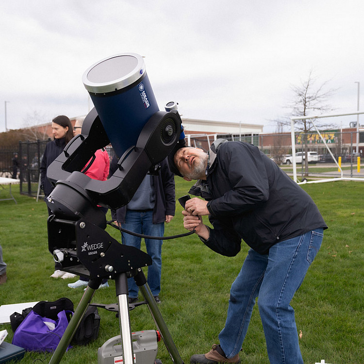Visitor using a large telescope to view the eclipse