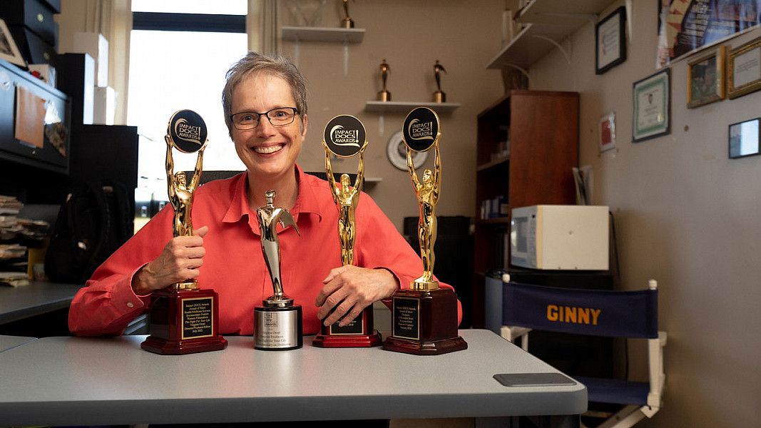 Ginny Orzel in her office with all her awards