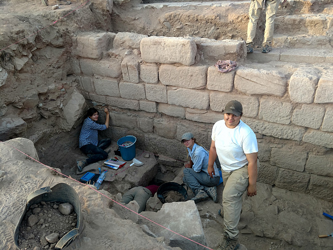Students excavating a wall