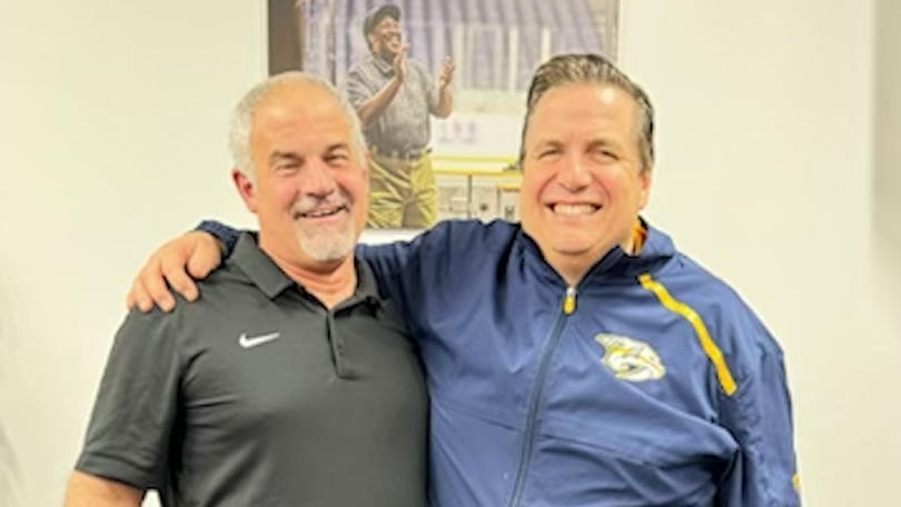 Brockport roommates Chris Scarlata ’90 and Pete Rogers ’89 (pictured left to right) reunite at a Predators game.