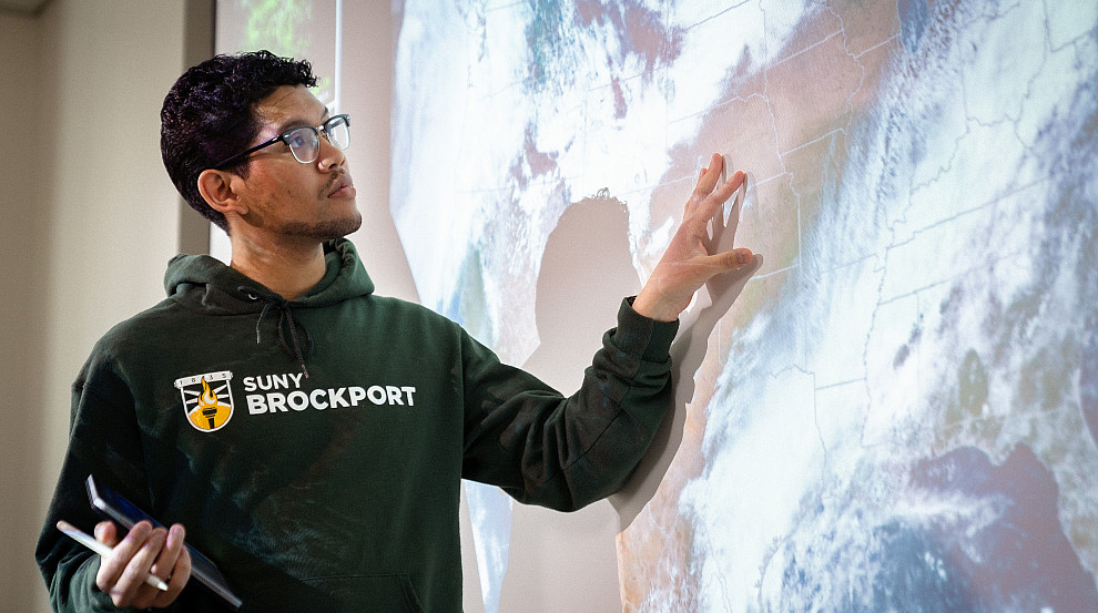 meteorology student by a projector