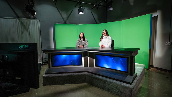 Students using the on-campus news set for a broadcast