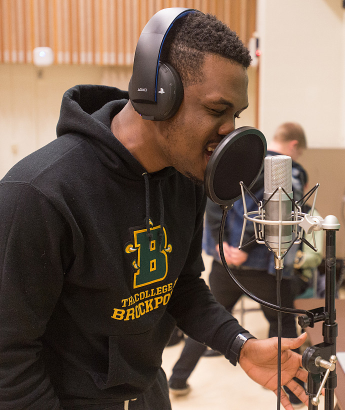 Student using a microphone with headphones on