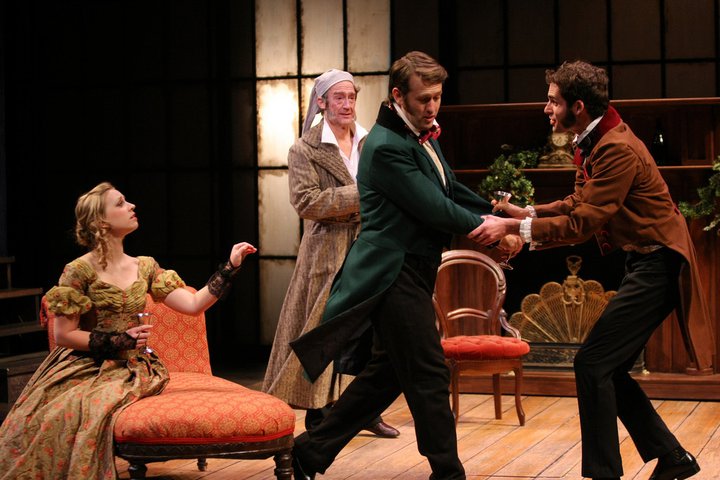 Actors and actresses singing on stage in A Christmas Carol