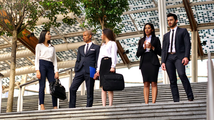 Business people on steps of a building
