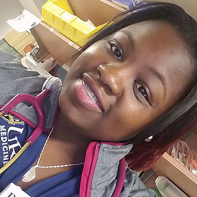 Aishia Wall at work in hospital with a stethoscope