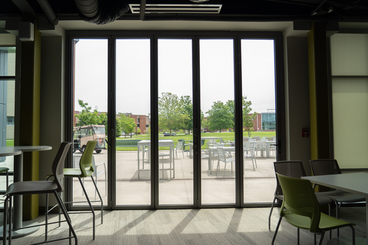 Wide view of shuttered windows in the Eagle Hall main lobby looking outwards towards the patio