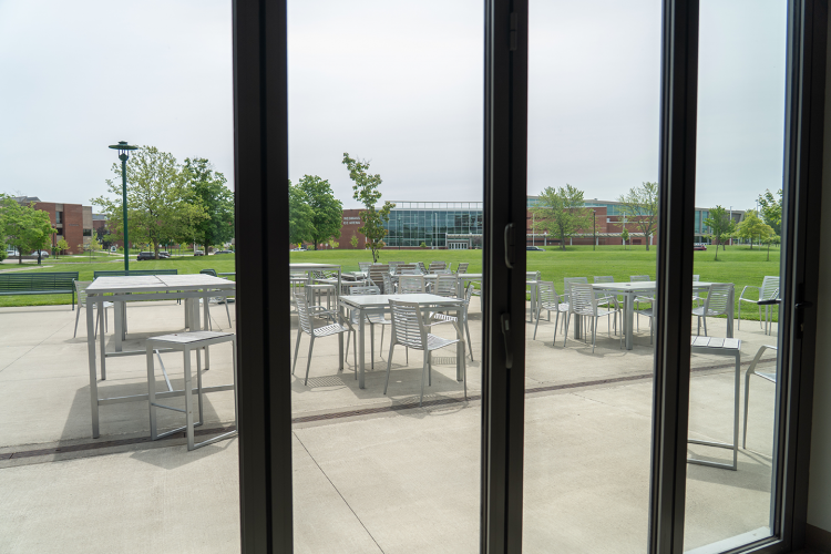 Close up of shuttered windows in the Eagle Hall main lobby looking outwards towards the patio and SERC