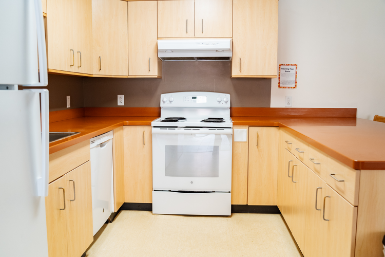 Closer look in the U-shaped layout kitchen focused on the stove and countertops