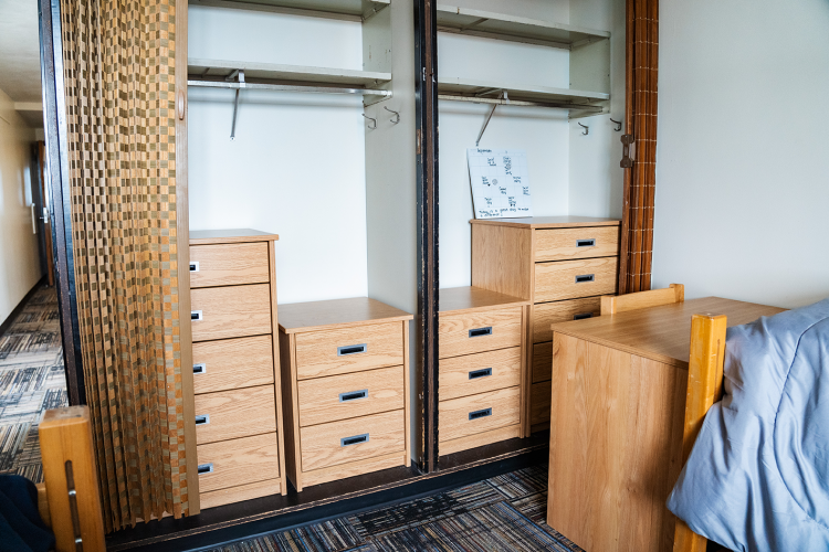 Close view of 2 closet spaces with 2 large dressers and 2 small dressers
