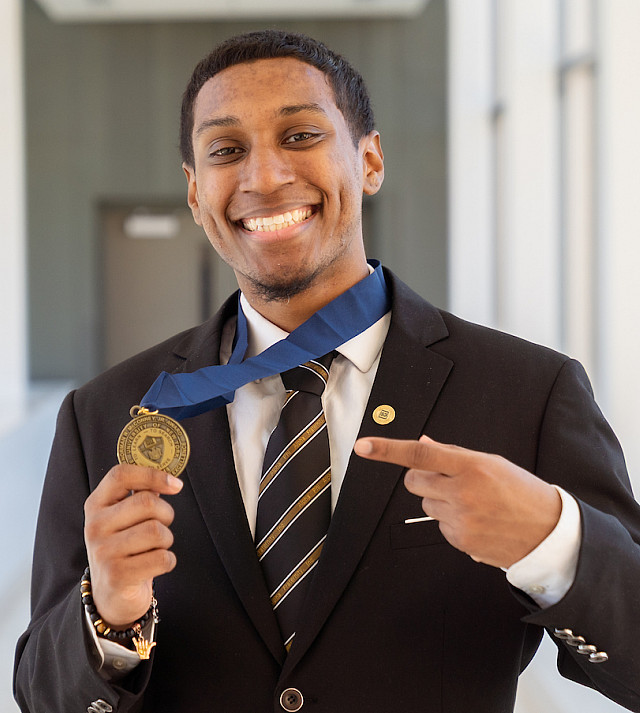 Carlos Clark holding his Resilience Award