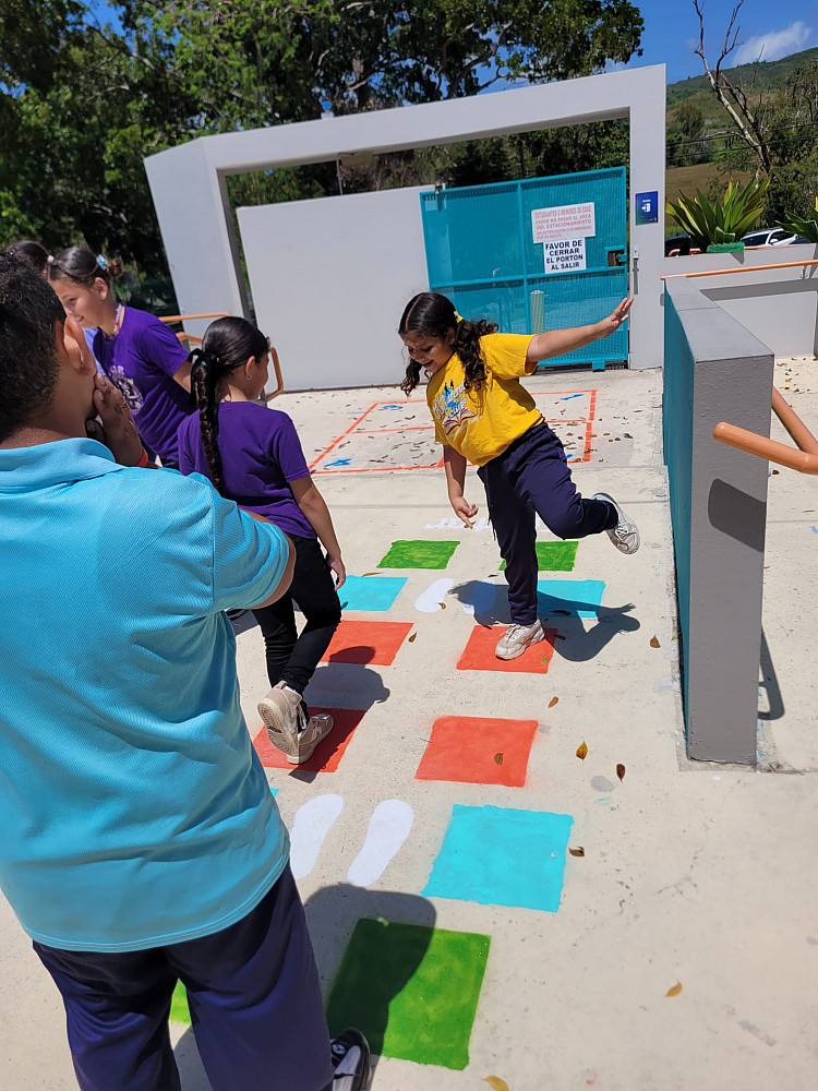 Children jumping on a painted game