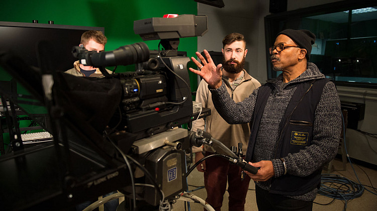 Carvin Eison (right) teaching a class on broadcasting.